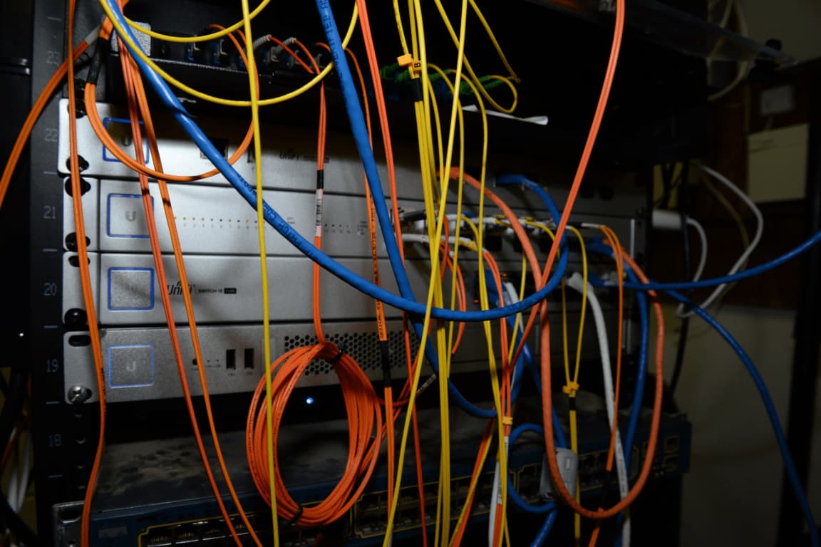Technician inspecting cabling in a server rack