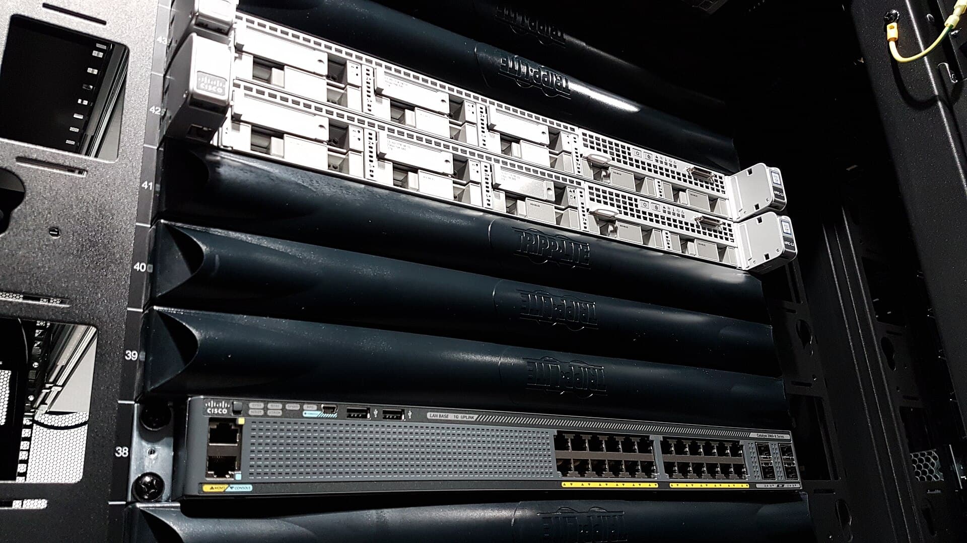 Engineer working on network infrastructure in a server room